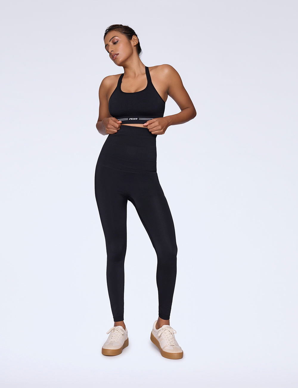 Woman wearing high-waist and high-rise black shaping leggings back view